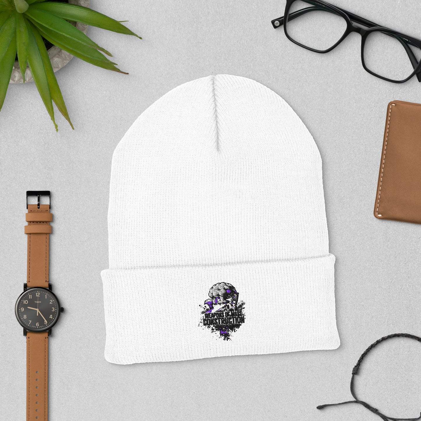 Bluecollaz general contractor cuffed White beanie design on a gray surface with a watch, glasses, and wallet.